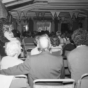 People watching slide show presenting Doc Rowe's photos