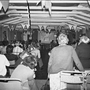 People watching slide show presenting Doc Rowe's photos