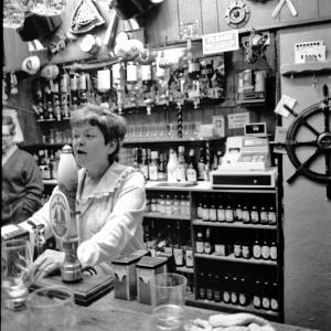 landlady behind bar in pub