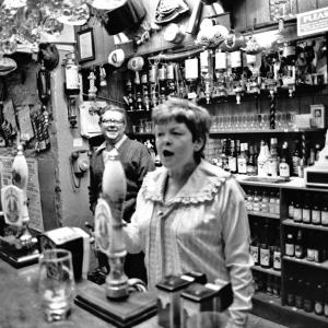 landlady behind bar in pub