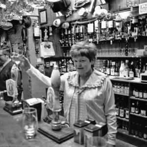 landlady behind bar in pub