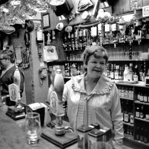 landlady behind bar in pub