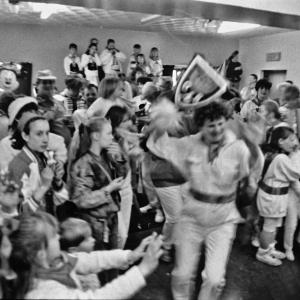teaser dancing surrounded by children