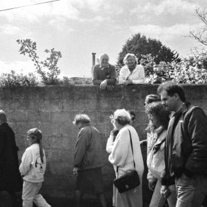 people walking beside wall