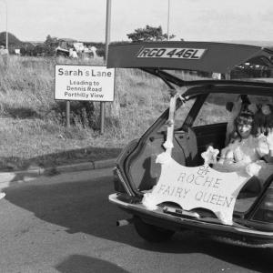 girl in boot of car in parade