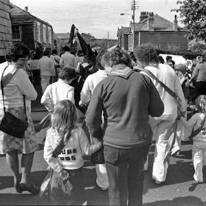 People walking behind Old Oss