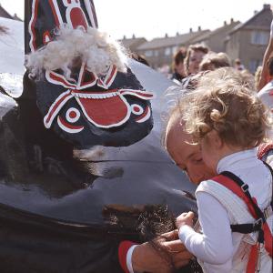 Old Oss shaking hands with child