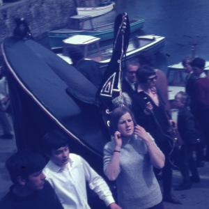 Blue Ribbon and people walking on harbourside