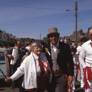 Old Oss Master of Ceremonies with man and woman, accordion players behind