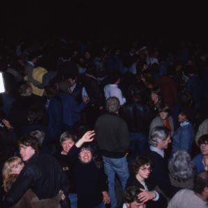 Crowd at night, person waving