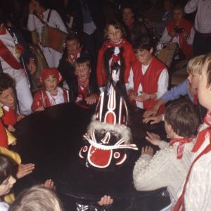 Children circled around Old Oss inside