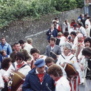 Old Oss accordion players walking in procession