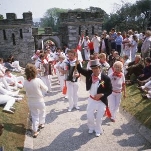 Old Oss dancers walking through Prideaux Place gate