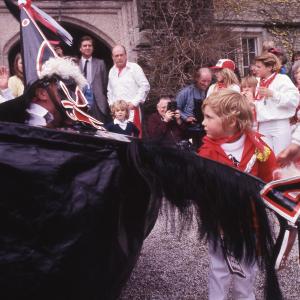 Child stroking Old Oss' mane in front of Prideaux Place house