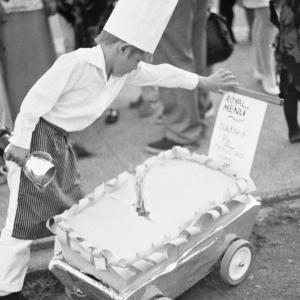 boy dressed as chef with giant pie