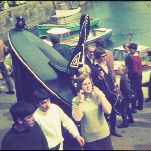 Blue Ribbon and people walking on harbourside
