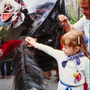 Old Oss being stroked by little girl and man