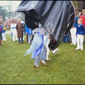 Man and woman's legs under Blue Ribbon Oss costume