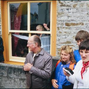 People watching from outside house