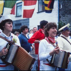 Women playing accordions in procession