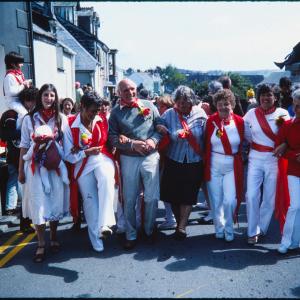 Old Oss party wearing sashes arm in arm
