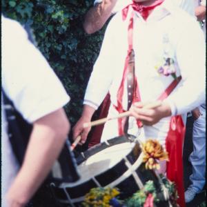 Old Oss band drummer walking through garden