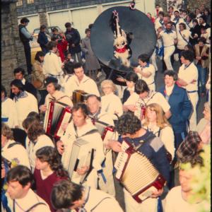 Blue Ribbon band walking along road in procession 