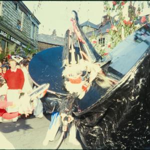 Woman teasing both the osses under the maypole