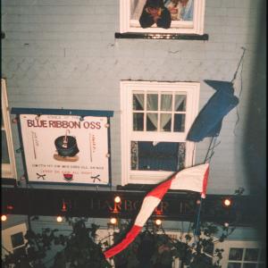 People looking out window above Harbour Inn