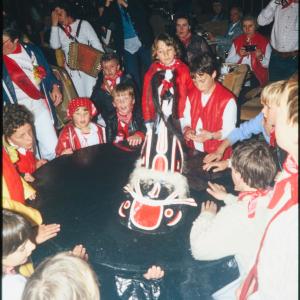 Children circled around Old Oss inside