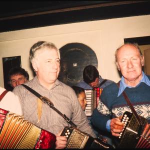 Men playing accordions in pub
