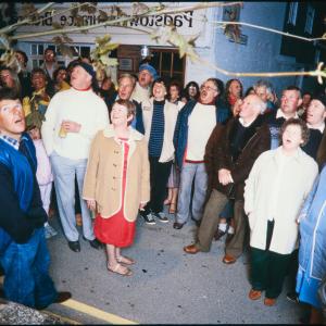 People singing on street corner at night