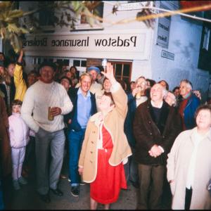People singing on street corner at night