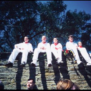 Boys from Old Oss sitting on wall in sun