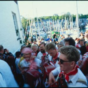 Old Oss musicians in procession beside quay