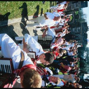 Old Oss accordion players walking up path to Prideaux Place