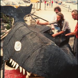 Men deconstructing carnival whale