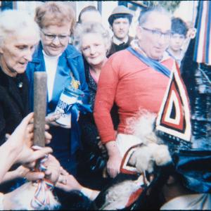Blue Ribbon rider surrounded by people