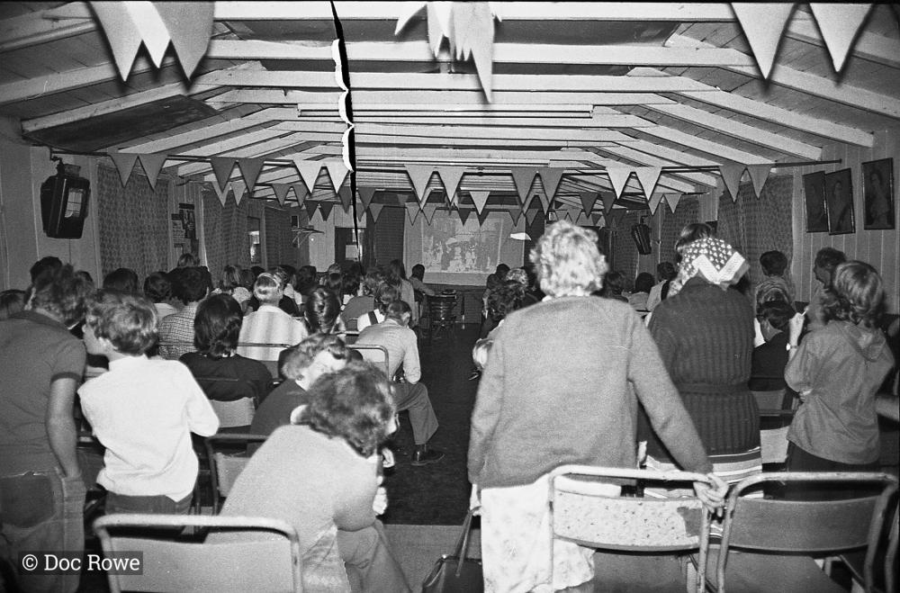 People watching slide show presenting Doc Rowe's photos