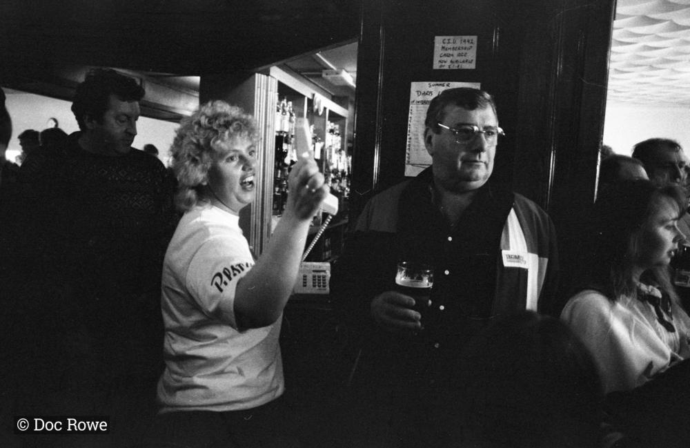 Woman with telephone in pub