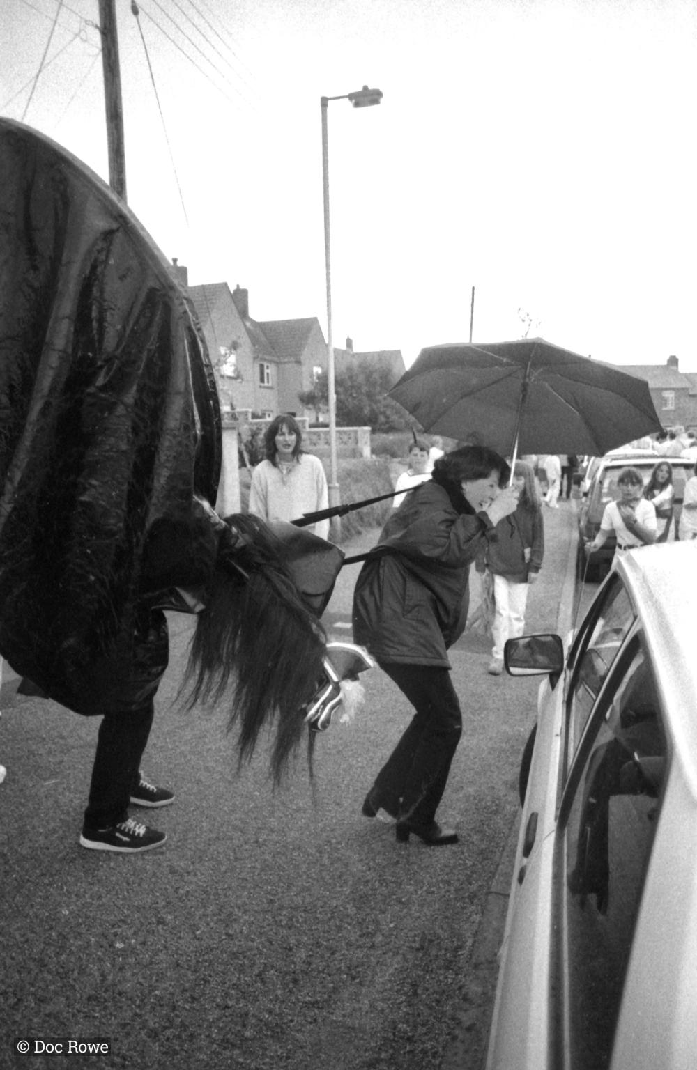 Old Oss woman in rain