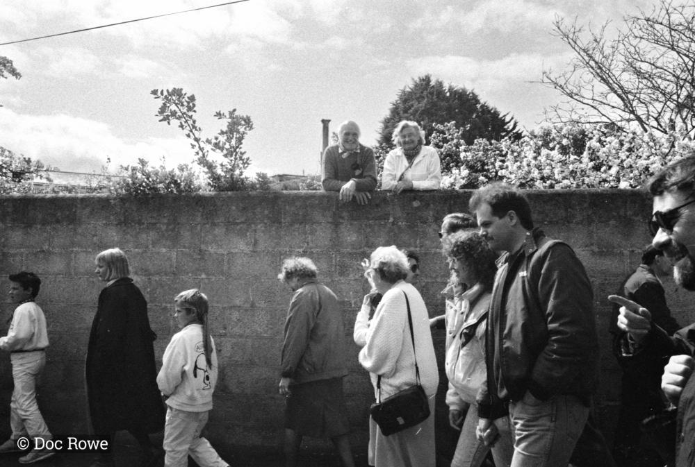 people walking beside wall