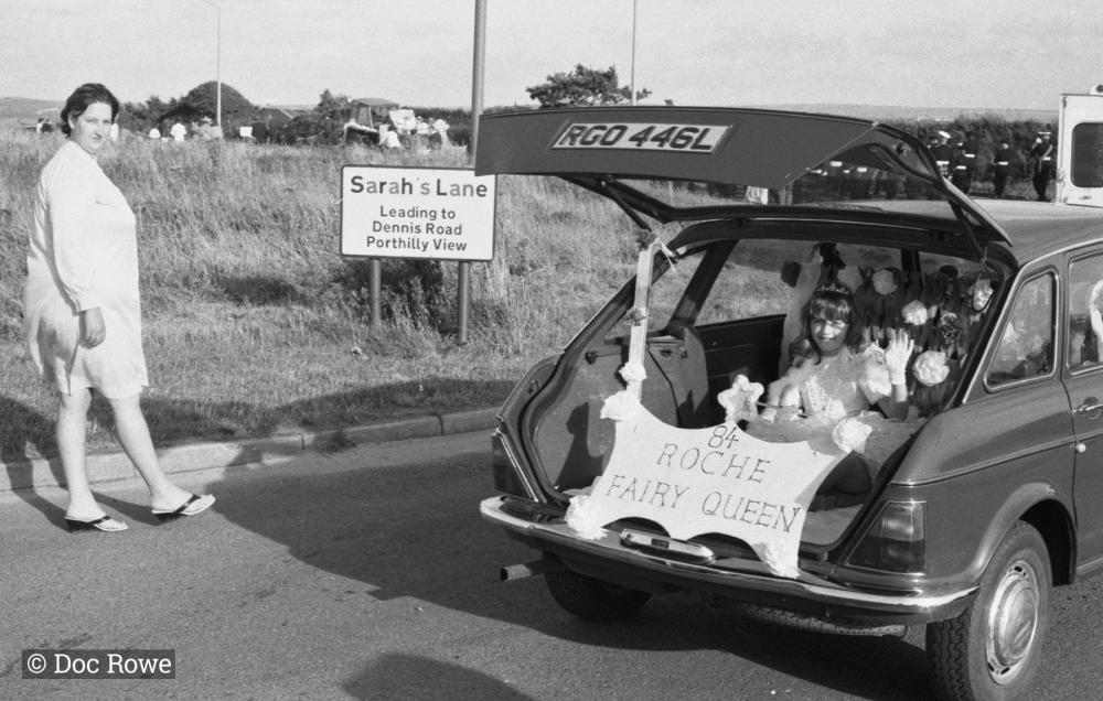 girl in boot of car in parade