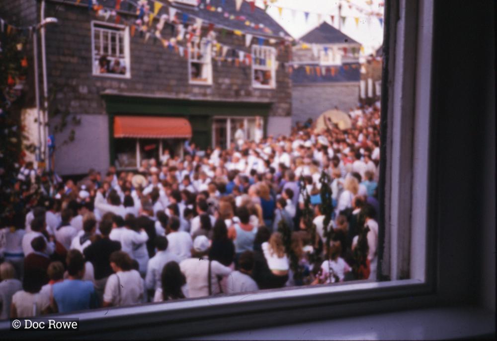 Crowds under maypole, from window