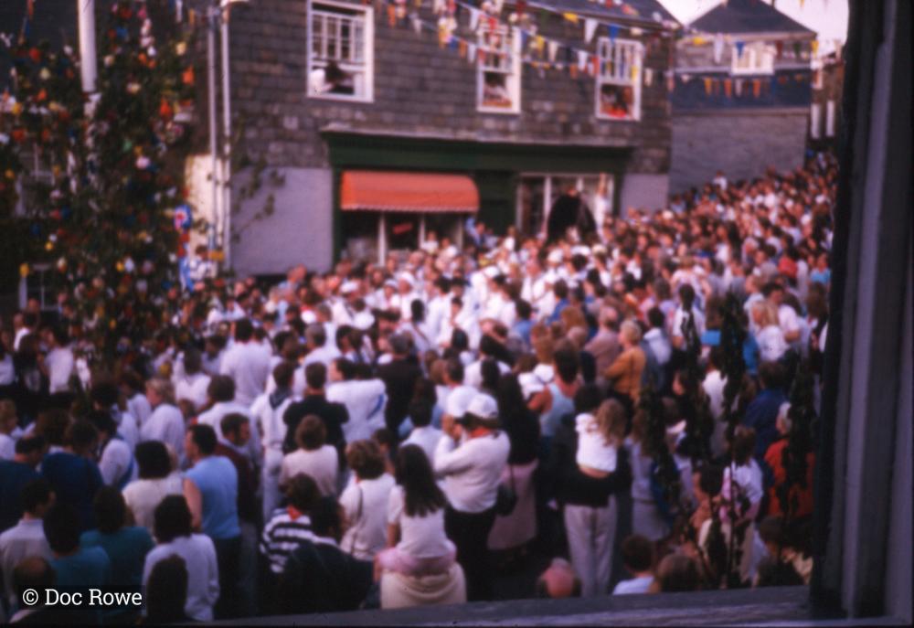 Crowds under maypole, from window
