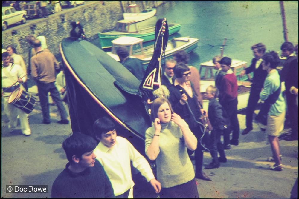 Blue Ribbon and people walking on harbourside
