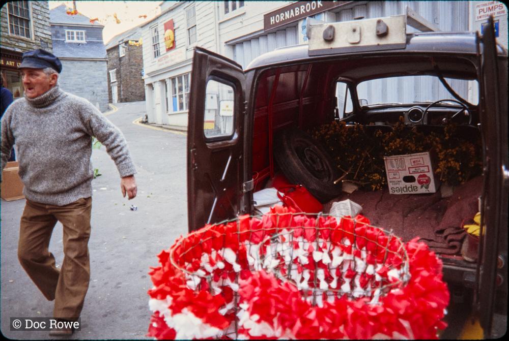 Early morning, van being unpacked as maypole is decorated