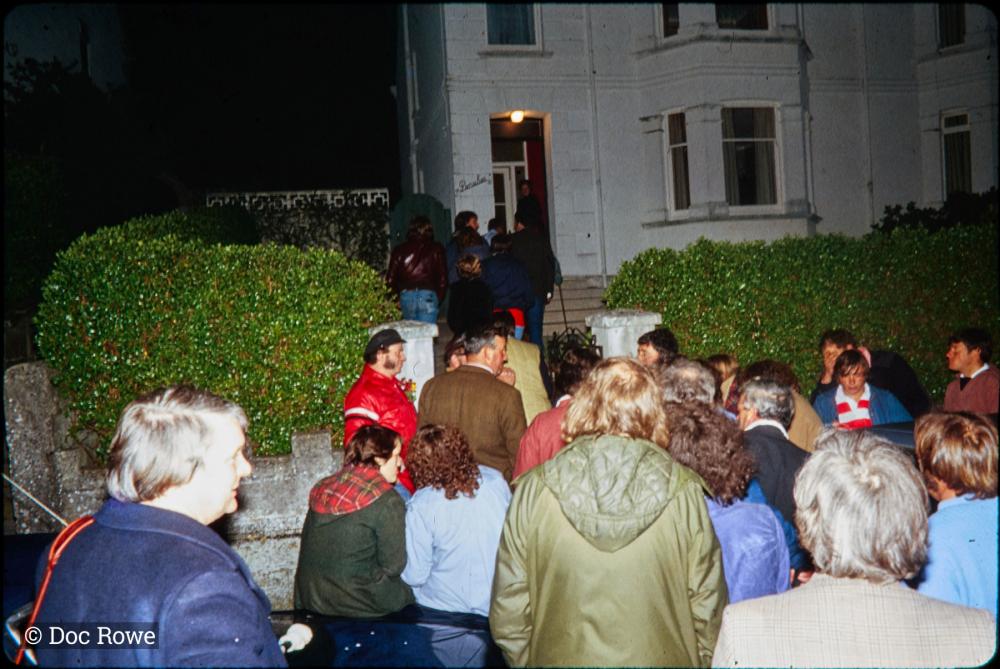 Night time, crowd gathered at gate
