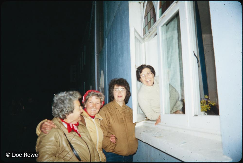 Night time, women talking through window