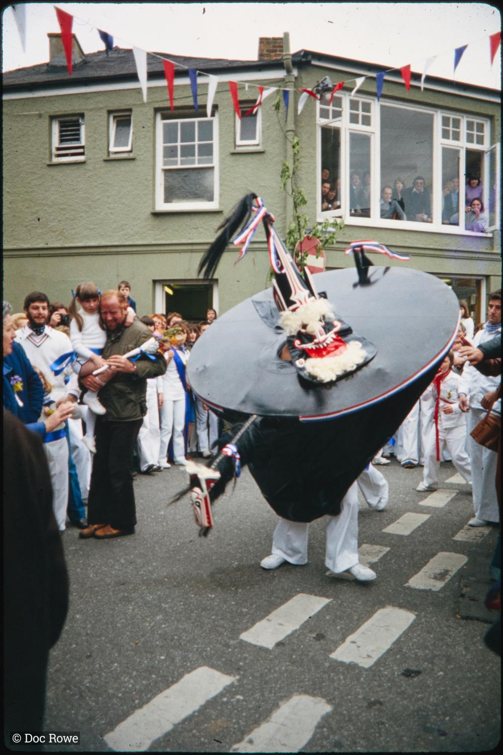 Child stood on window sill held up by woman